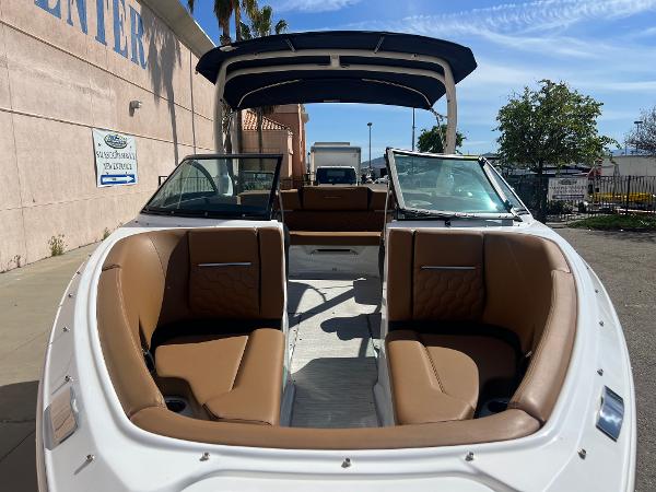 Slide: The Image of 2023 Four Winns H4 boat with tan leather seats and open bow design. - 3
