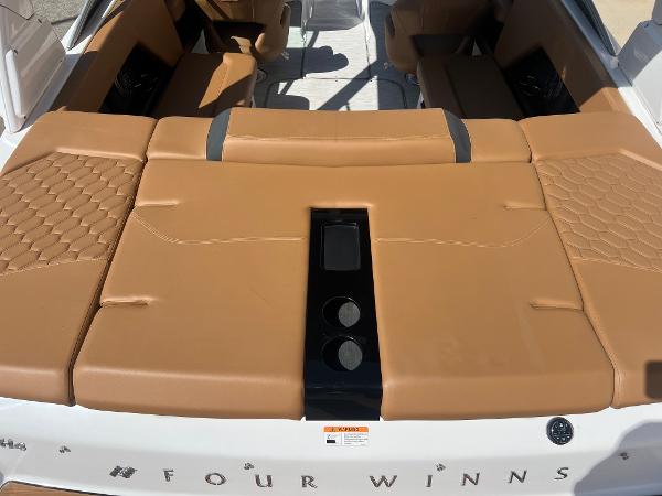 Slide: The Image of 2023 Four Winns H4 boat with tan leather seating and modern design. - 6