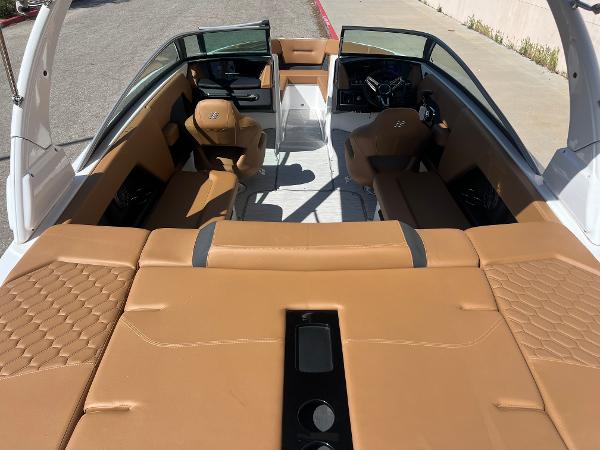 Slide: The Image of 2023 Four Winns H4 boat interior with tan leather seating and modern dashboard. - 7