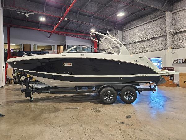 Slide: The Image of 2024 Four Winns HD5 Surf boat in showroom on trailer. - 0