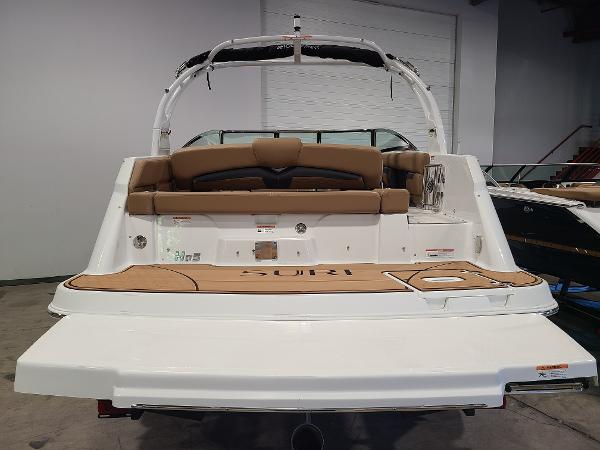Slide: The Image of 2024 Four Winns HD5 Surf boat, rear view, in a showroom. - 3