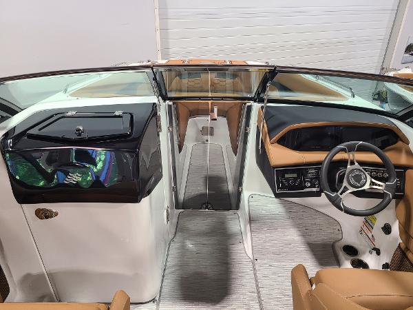 Slide: The Image of 2024 Four Winns HD5 Surf boat interior with modern dashboard and seating. - 5