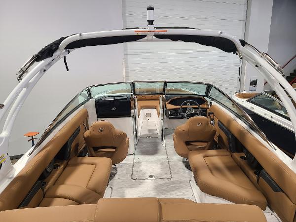 Slide: The Image of 2024 Four Winns HD5 Surf boat interior with tan leather seating and modern dashboard. - 7