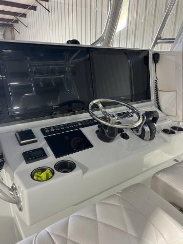 Slide: The Image of Freeman 42LR 2021 boat dashboard with steering wheel and control panel. - 6
