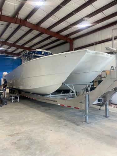 Slide: The Image of 2021 Freeman 42LR boat on trailer in indoor storage facility. - 8