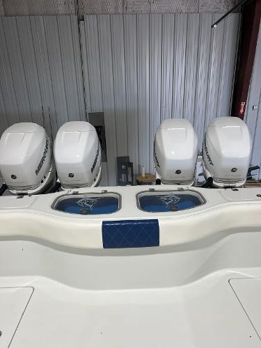 Slide: The Image of 2021 Freeman 42LR boat with four powerful outboard engines in a storage facility. - 9
