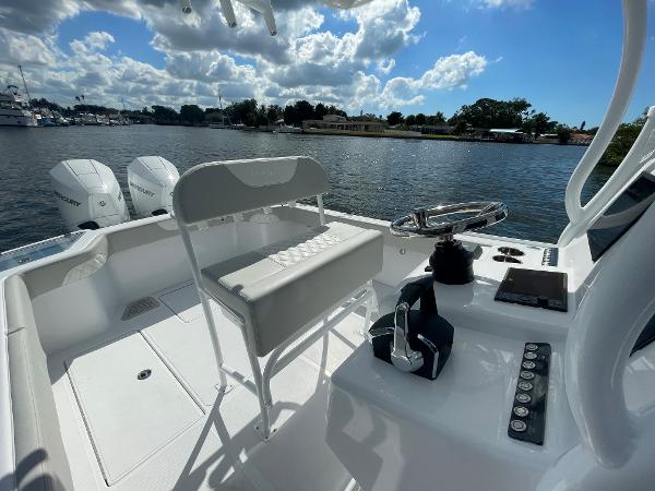 Slide: The Image of 2024 Front Runner 26 Center Console boat interior with dual engines, steering console, and seating. - 14