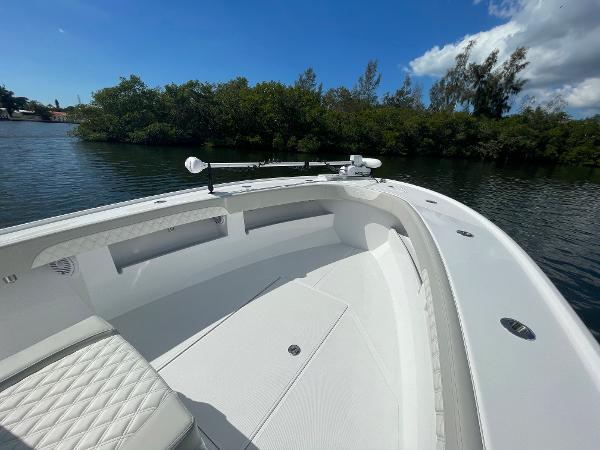Slide: The Image of 2024 Front Runner 26 Center Console boat on calm water with lush greenery in the background. - 15