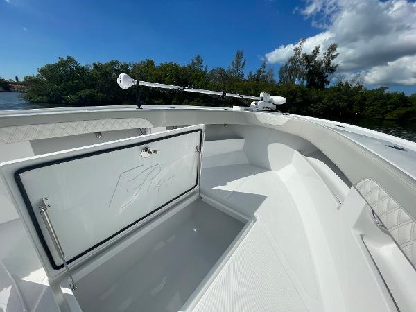 Slide: The Image of 2024 Front Runner 26 Center Console boat with open storage compartment. - 16