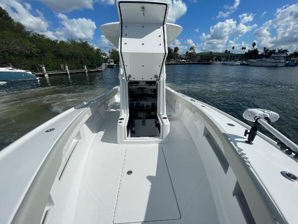 Slide: The Image of 2024 Front Runner 26 Center Console boat on calm water with open storage compartment. - 17