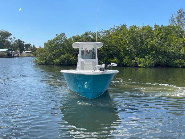 Slide: The Image of 2024 Front Runner 26 Center Console boat cruising on a calm river. - 2