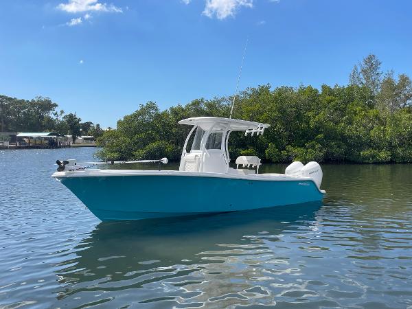 Slide: The Image of 2024 Front Runner 26 Center Console boat on calm water with lush greenery in the background. - 4