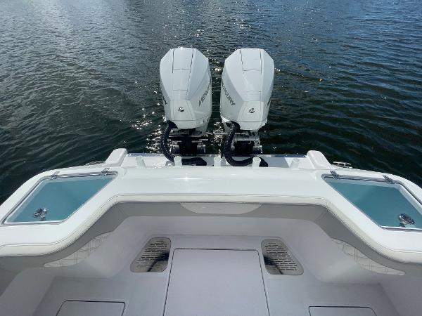 Slide: The Image of 2024 Front Runner 26 Center Console with twin outboard engines on the water. - 7