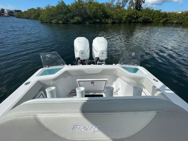 Slide: The Image of 2024 Front Runner 26 Center Console boat with twin engines on a calm waterway. - 9