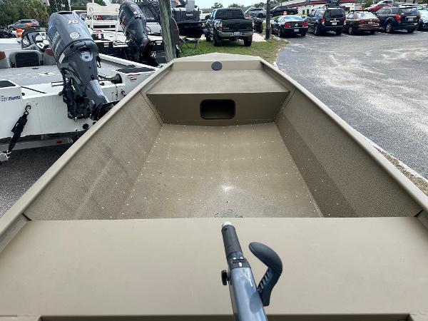 Slide: The Image of 2023 G3 1652 VBW boat, interior view, parked in a lot with other boats and vehicles. - 6