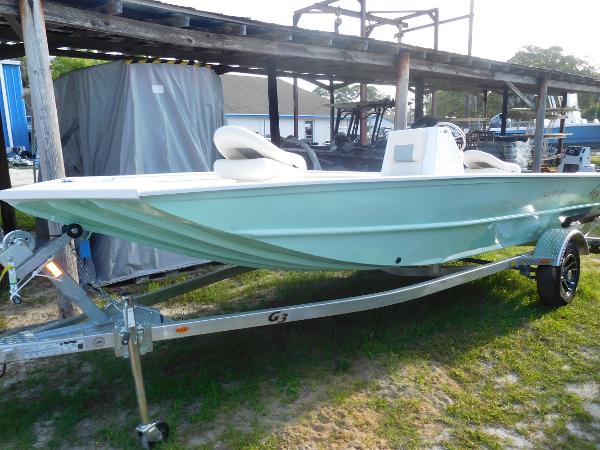 Slide: The Image of 2023 G3 Bay 17 boat on trailer, light blue hull, parked outdoors. - 1