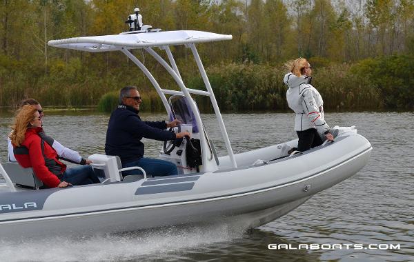 Slide: The Image of People enjoying a ride on a 2024 Gala VIKING V500 boat on a calm river. - 11