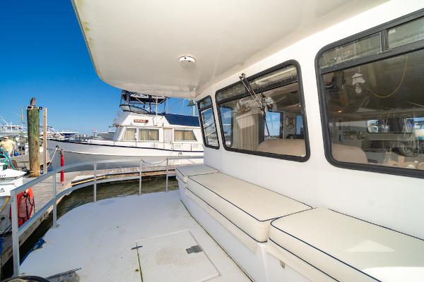 Slide: The Image of 2003 Gibson 47 Classic yacht with spacious deck and seating at marina. - 11