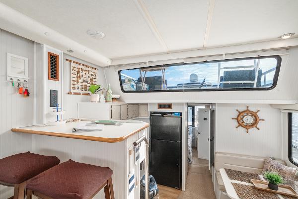 Slide: The Image of Interior of 2003 Gibson 47 Classic boat with modern kitchen and seating area. - 17