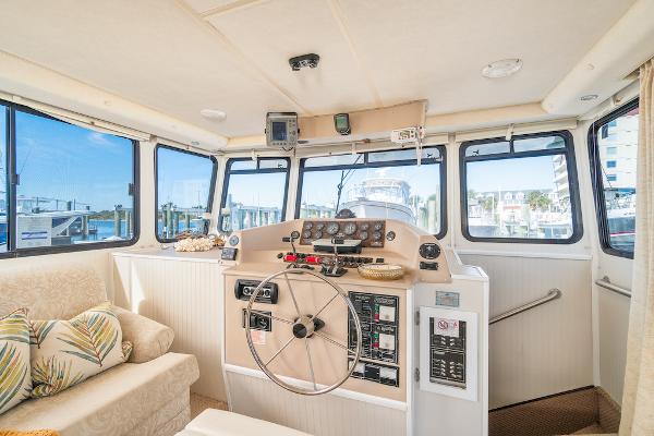 Slide: The Image of Interior of 2003 Gibson 47 Classic boat with helm, steering wheel, and comfortable seating. - 18