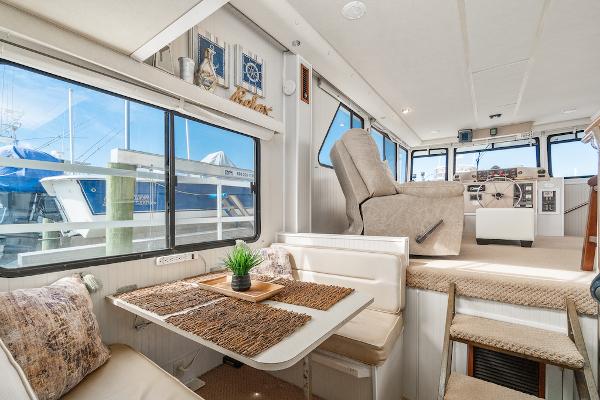Slide: The Image of Interior of a 2003 Gibson 47 Classic yacht with dining area and helm. - 19