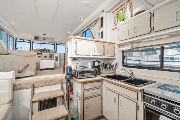 Slide: The Image of Interior of 2003 Gibson 47 Classic boat with modern kitchen and helm area. - 22
