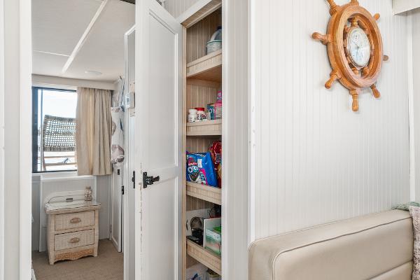 Slide: The Image of Interior of 2003 Gibson 47 Classic boat with nautical decor and storage shelves. - 25