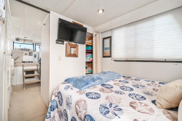 Slide: The Image of Cozy bedroom in 2003 Gibson 47 Classic houseboat with nautical decor and modern amenities. - 28