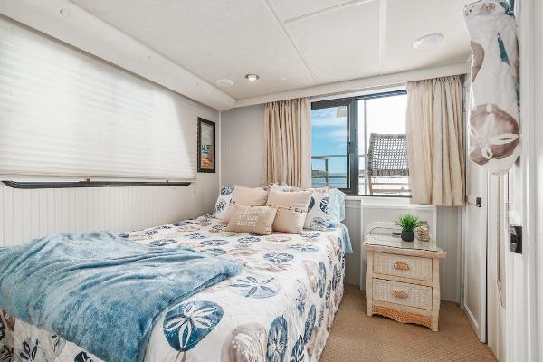 Slide: The Image of Cozy bedroom in 2003 Gibson 47 Classic houseboat with nautical decor and window view. - 29