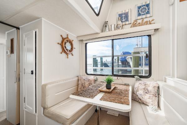 Slide: The Image of Cozy dining area in 2003 Gibson 47 Classic boat with nautical decor and window view. - 30