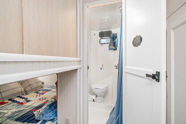 Slide: The Image of 2003 Gibson 47 Classic boat interior with cozy bedroom and compact bathroom. - 31