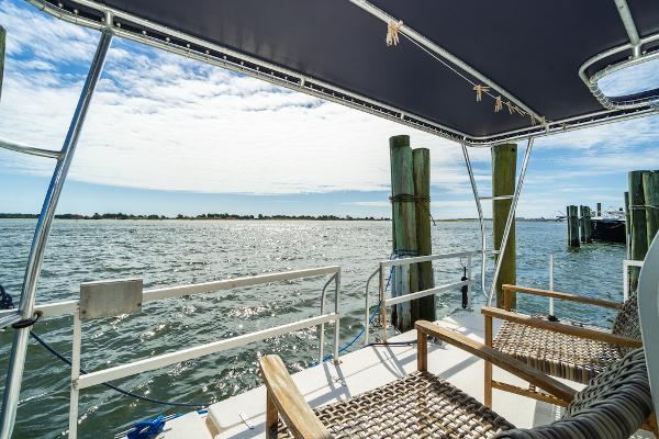 Slide: The Image of View from 2003 Gibson 47 Classic boat deck overlooking serene water and sky. - 32