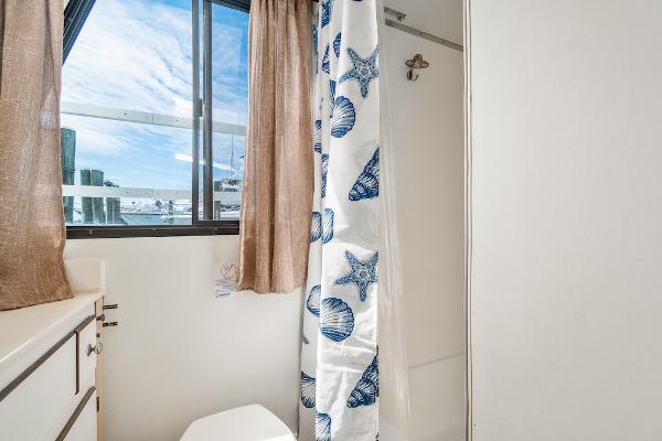 Slide: The Image of Bathroom in 2003 Gibson 47 Classic boat with nautical-themed shower curtain. - 35