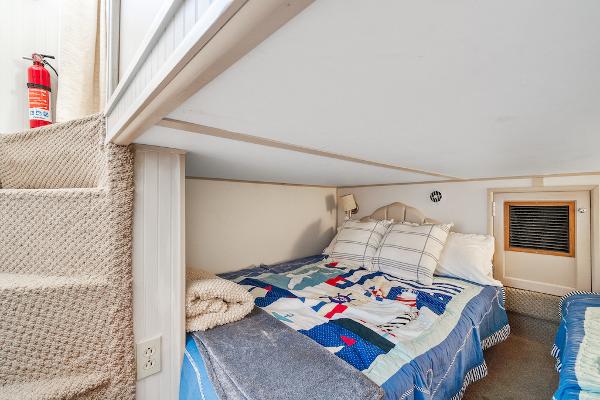 Slide: The Image of Cozy bedroom with nautical-themed bedding in a 2003 Gibson 47 Classic boat. - 37