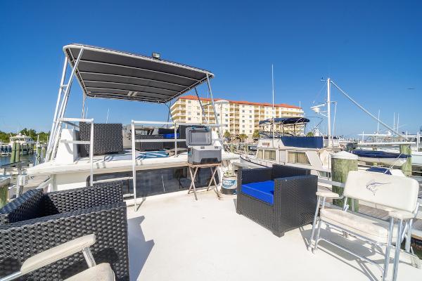 Slide: The Image of Gibson 47 Classic 2003 yacht deck with seating, marina view, and clear blue sky. - 5