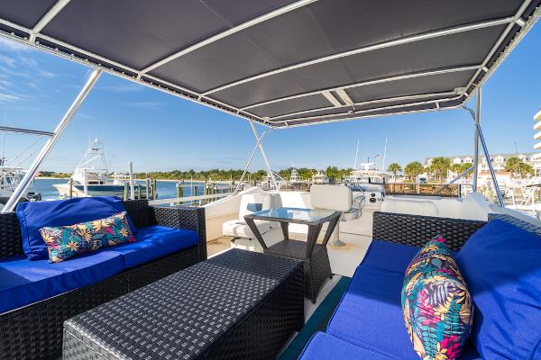 Slide: The Image of 2003 Gibson 47 Classic yacht with blue seating and marina view. - 7