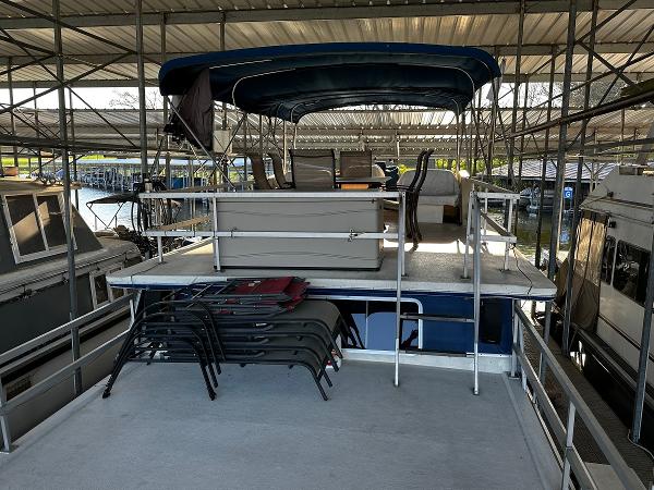 Slide: The Image of 1987 Gibson 50 Classic houseboat with upper deck and canopy in marina. - 13