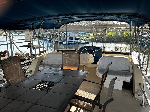 Slide: The Image of 1987 Gibson 50 Classic houseboat with covered outdoor seating area and dining table. - 15