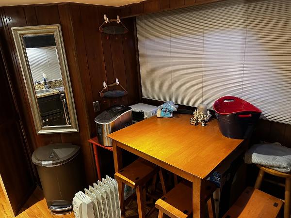 Slide: The Image of Cozy kitchen corner with wooden table, stools, and various appliances. - 21