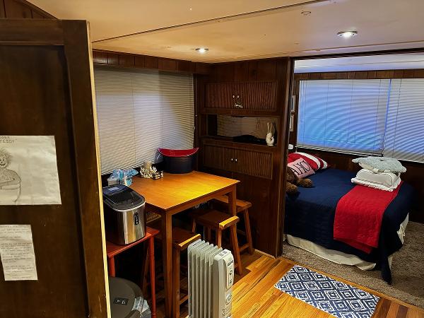 Slide: The Image of Cozy interior of a 1987 Gibson 50 Classic boat with dining area and bedroom. - 23