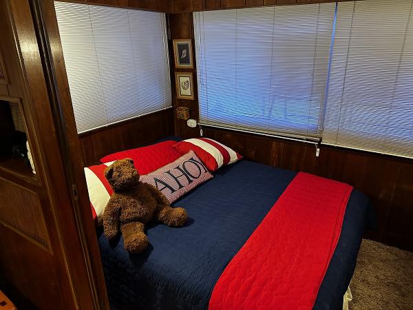 Slide: The Image of Cozy bedroom with nautical-themed bedding and a teddy bear on the bed. - 24