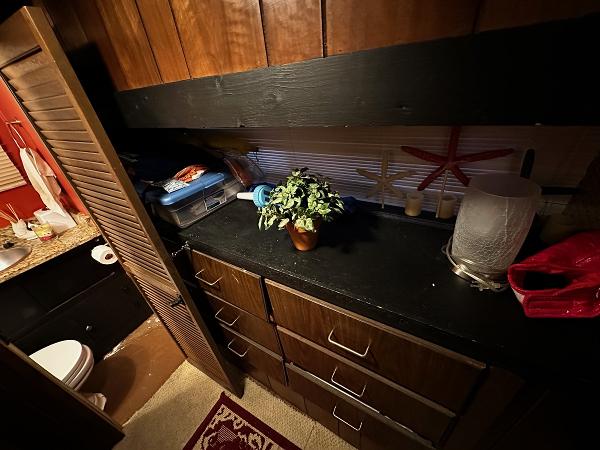 Slide: The Image of 1987 Gibson 50 Classic boat interior with wooden cabinets and countertop. - 30