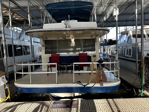 Slide: The Image of 1987 Gibson 50 Classic houseboat docked in a marina. - 8