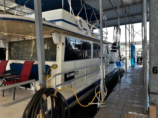 Slide: The Image of 1987 Gibson 50 Classic houseboat docked in a covered marina. - 9