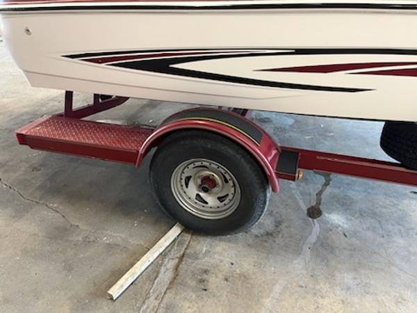 Slide: The Image of 2007 Glastron GT185 boat trailer with red accents and stylish design. - 14