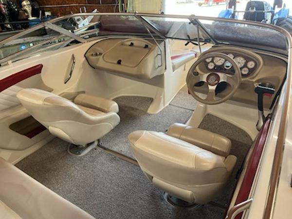 Slide: The Image of 2007 Glastron GT185 boat interior with beige seats and dashboard controls. - 4