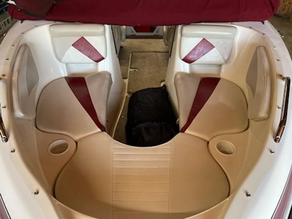 Slide: The Image of 2007 Glastron GT185 boat interior with beige and red seating. - 8
