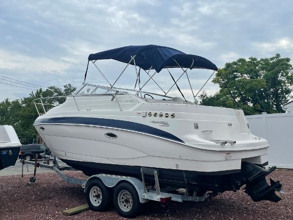 Slide: The Image of 2009 Glastron GT 249 boat on trailer with blue canopy. - 1