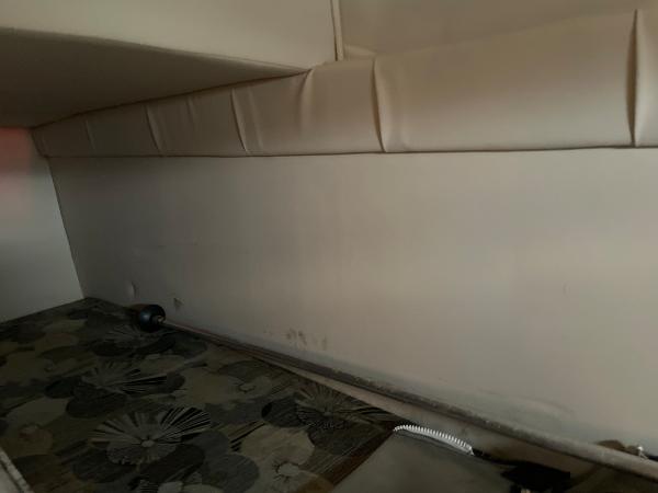 Slide: The Image of Interior cabin of 2009 Glastron GT 249 boat with padded walls and patterned flooring. - 19