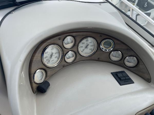 Slide: The Image of Dashboard of a 2009 Glastron GT 249 boat with gauges and controls. - 9